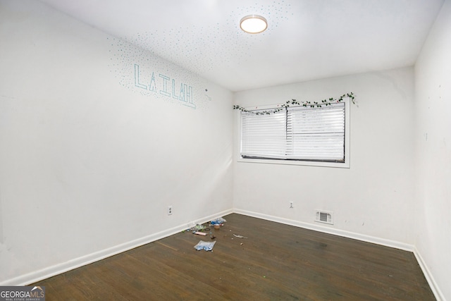 empty room with dark hardwood / wood-style floors