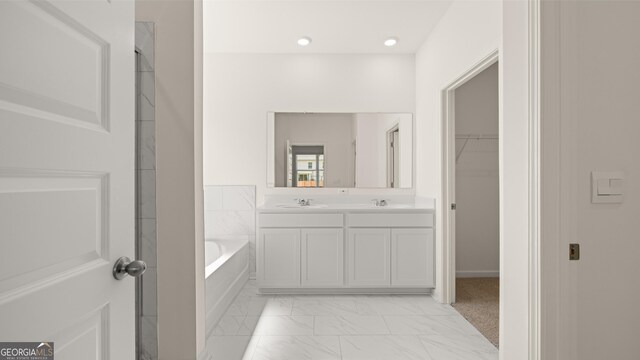 bathroom featuring a bathing tub and vanity