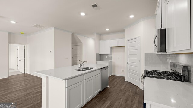 kitchen with stainless steel appliances, sink, a center island with sink, dark hardwood / wood-style floors, and white cabinetry