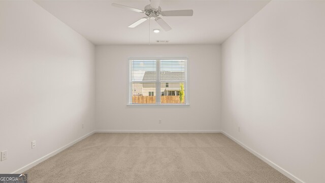 spare room featuring ceiling fan and light colored carpet
