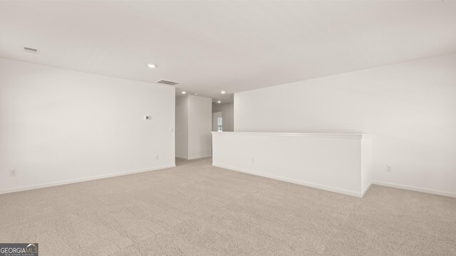 empty room featuring light carpet