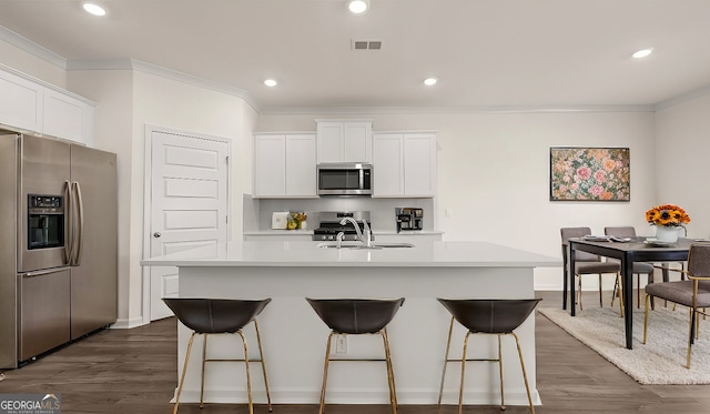 kitchen featuring white cabinets, sink, an island with sink, and stainless steel appliances