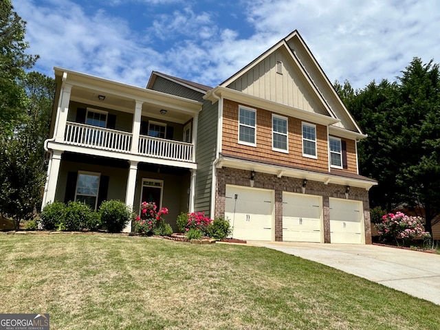 craftsman-style home featuring a balcony, a front yard, and a garage