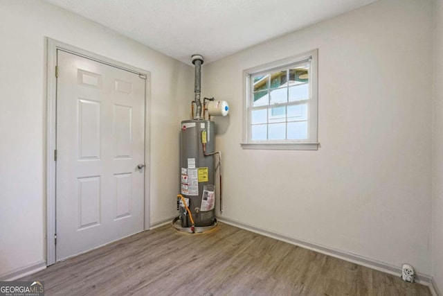 utility room with gas water heater