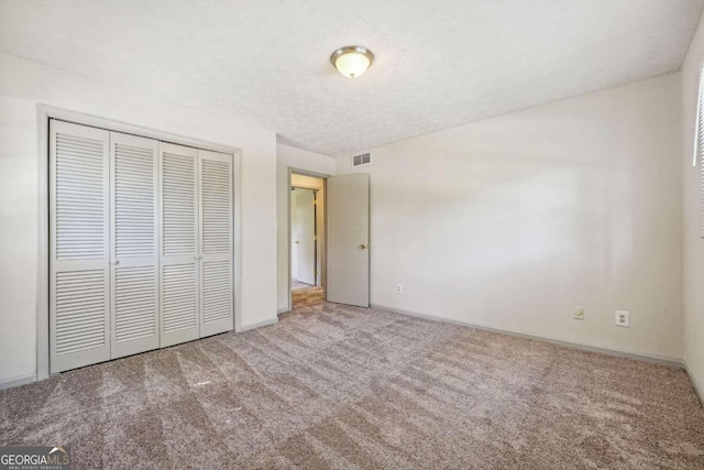 unfurnished bedroom with a closet and carpet