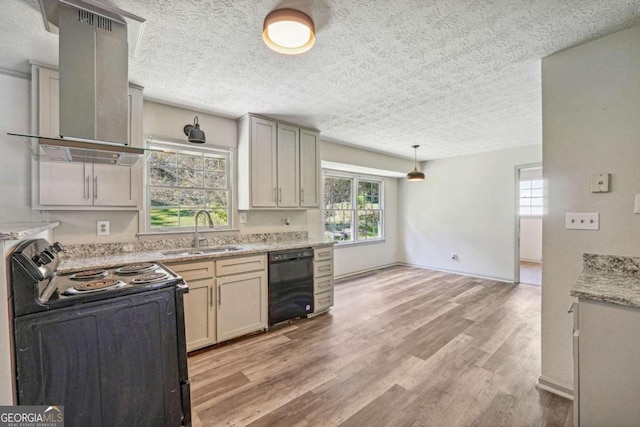 kitchen with wall chimney exhaust hood, sink, black appliances, decorative light fixtures, and light wood-type flooring