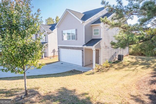 view of front of house featuring a front yard and a garage