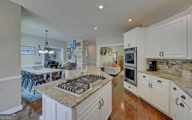 715 Cross Creek Dr, Toccoa, GA 30577 - kitchen featuring open floor plan, stainless steel appliances, dark wood finished floors, tasteful backsplash, and light stone counters
