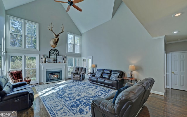 living room with dark wood-type flooring, ceiling fan, high vaulted ceiling, and ornamental molding