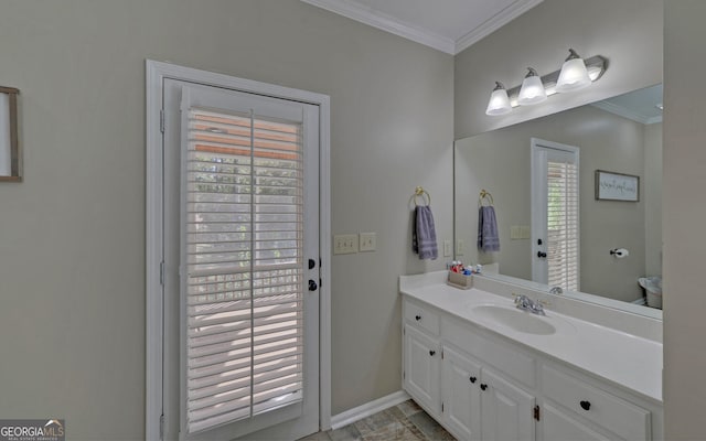 bathroom with a wealth of natural light, vanity, and crown molding