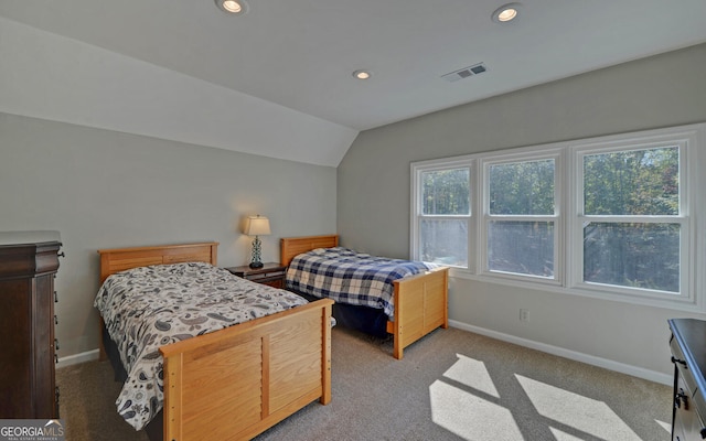 bedroom with lofted ceiling and light colored carpet