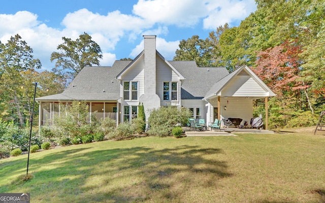 715 Cross Creek Dr, Toccoa, GA 30577 - back of property with a patio, a chimney, a lawn, a sunroom, and a shingled roof