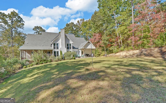 back of house with a yard and covered porch