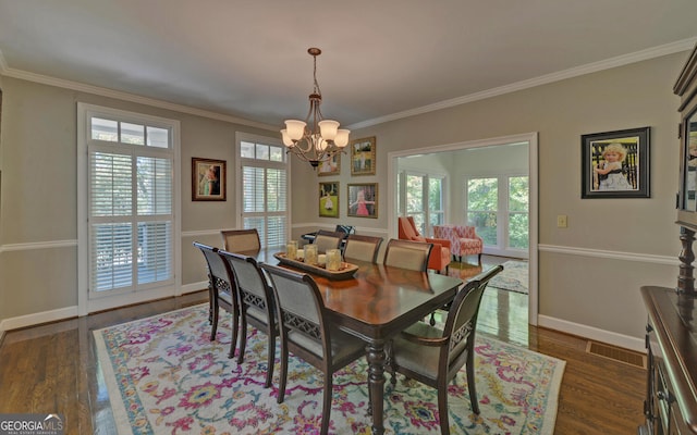 dining area featuring a notable chandelier, a healthy amount of sunlight, ornamental molding, and dark hardwood / wood-style flooring