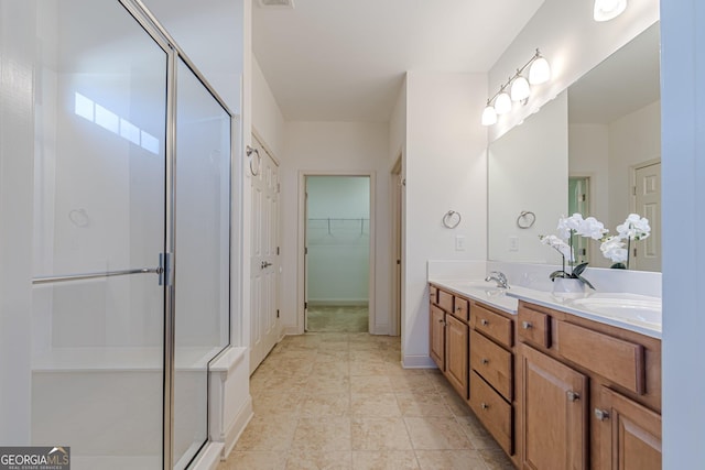 bathroom with vanity and a shower with door