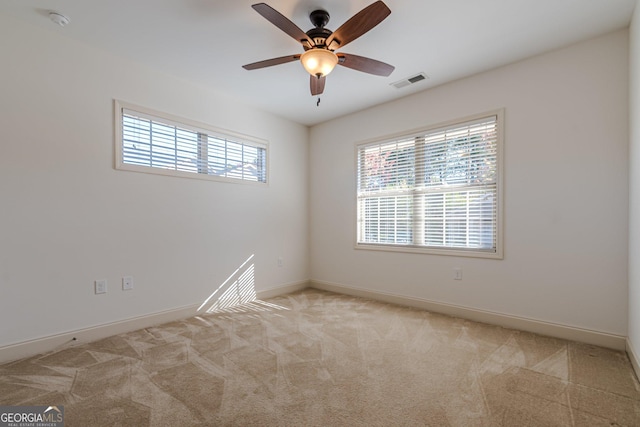 unfurnished room featuring light carpet and ceiling fan