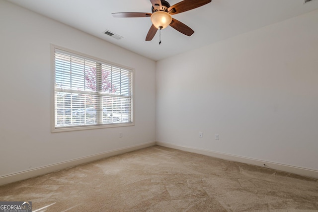 unfurnished room with light colored carpet and ceiling fan