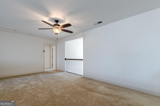 spare room with light colored carpet and ceiling fan