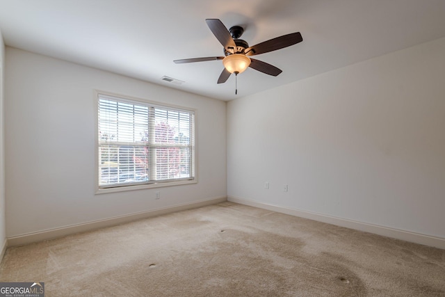 carpeted spare room with ceiling fan