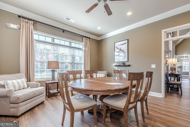 dining room featuring ornamental molding, ceiling fan, and light hardwood / wood-style floors