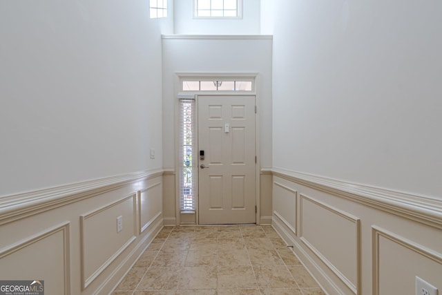 foyer entrance with a towering ceiling