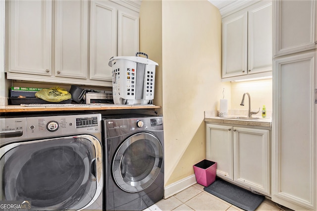 clothes washing area featuring cabinets, washing machine and dryer, sink, and light tile patterned flooring