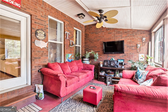 sunroom featuring ceiling fan, plenty of natural light, wood ceiling, and lofted ceiling