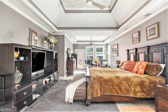 carpeted bedroom with ornamental molding, ceiling fan, and a raised ceiling