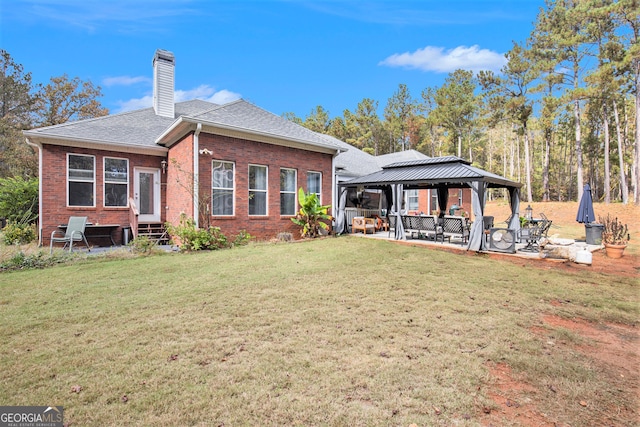 back of house with a patio area, a lawn, and a gazebo