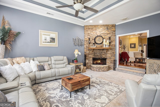 living room featuring a fireplace, ceiling fan, and crown molding