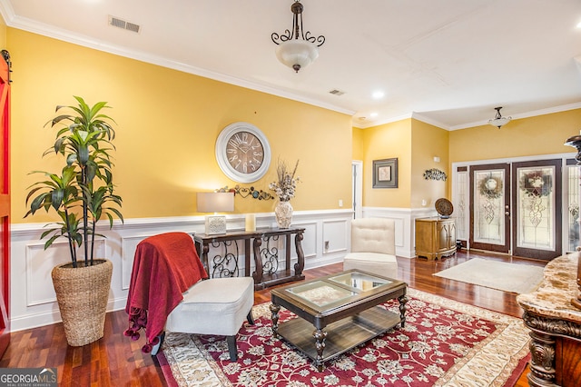 sitting room featuring ornamental molding, french doors, and hardwood / wood-style flooring