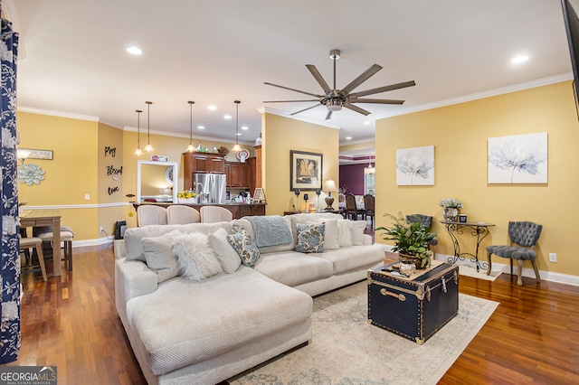 living room featuring dark hardwood / wood-style flooring, ceiling fan, and ornamental molding