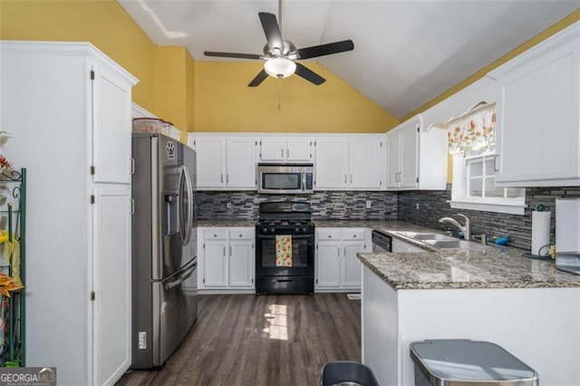 kitchen with sink, dark hardwood / wood-style flooring, kitchen peninsula, stainless steel appliances, and white cabinets