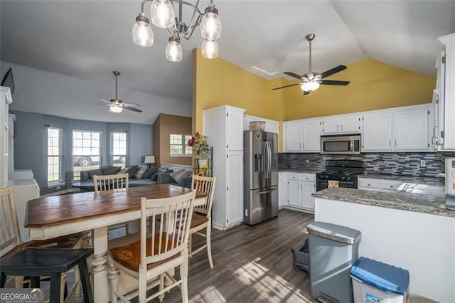 kitchen with stainless steel appliances, pendant lighting, white cabinets, light stone counters, and dark hardwood / wood-style flooring