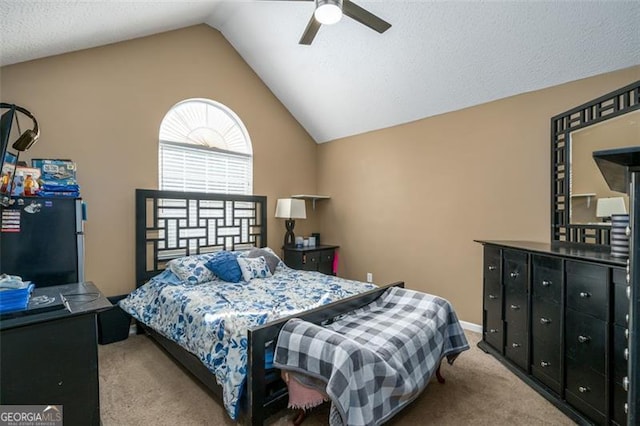 carpeted bedroom with black fridge, vaulted ceiling, and ceiling fan