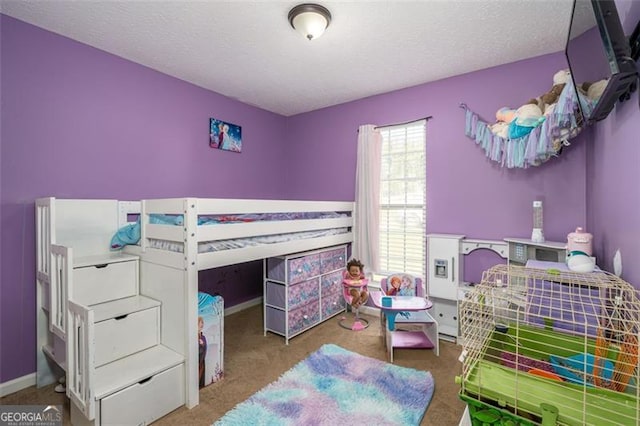 bedroom featuring carpet and a textured ceiling