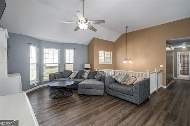 living room featuring ceiling fan with notable chandelier, vaulted ceiling, and dark hardwood / wood-style floors