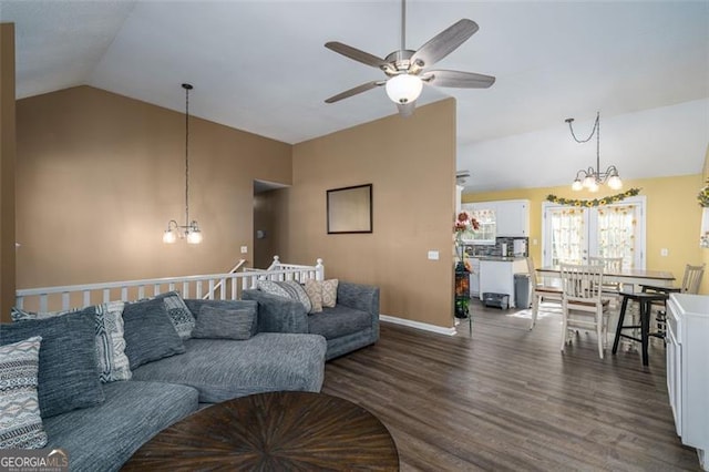 living room featuring hardwood / wood-style floors, ceiling fan with notable chandelier, and vaulted ceiling