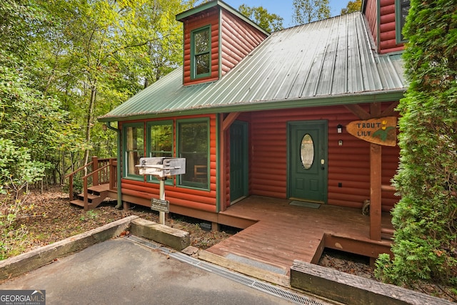 view of front facade with a wooden deck