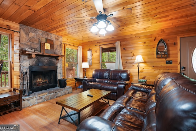 living room with wood ceiling, a fireplace, wood-type flooring, and wood walls