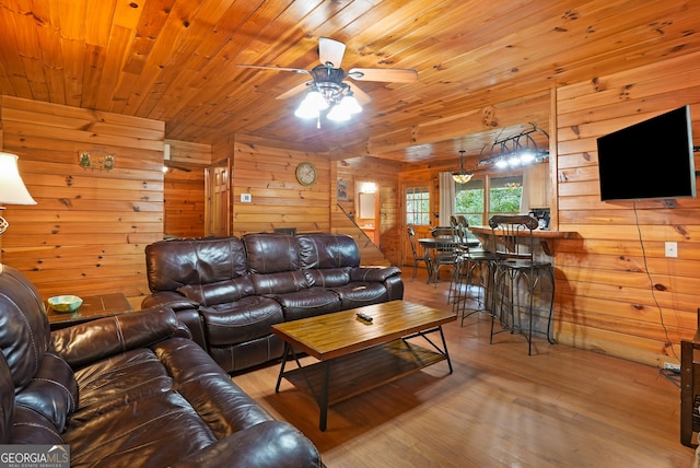 living room featuring wood walls, hardwood / wood-style floors, wood ceiling, and ceiling fan