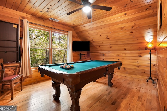 rec room featuring light hardwood / wood-style floors, vaulted ceiling, pool table, and wooden walls