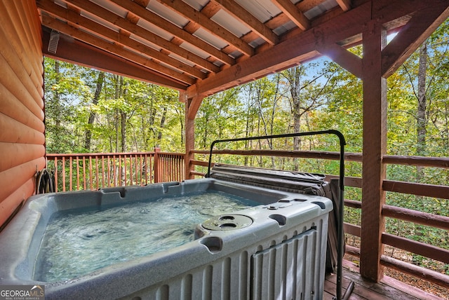 wooden deck with a hot tub