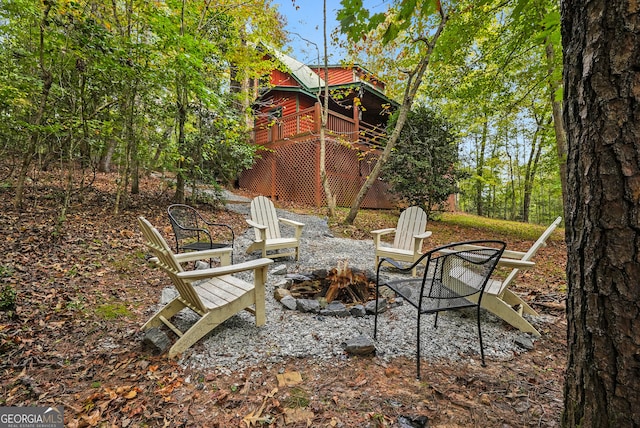 view of patio featuring an outdoor fire pit and a deck