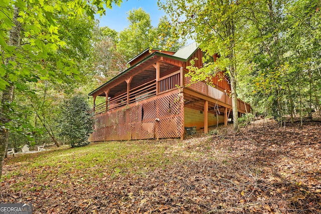 rear view of property featuring a deck