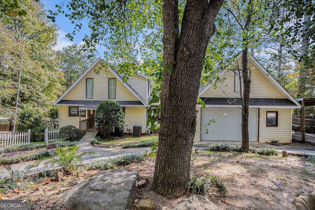 view of front of house featuring central AC unit and a garage