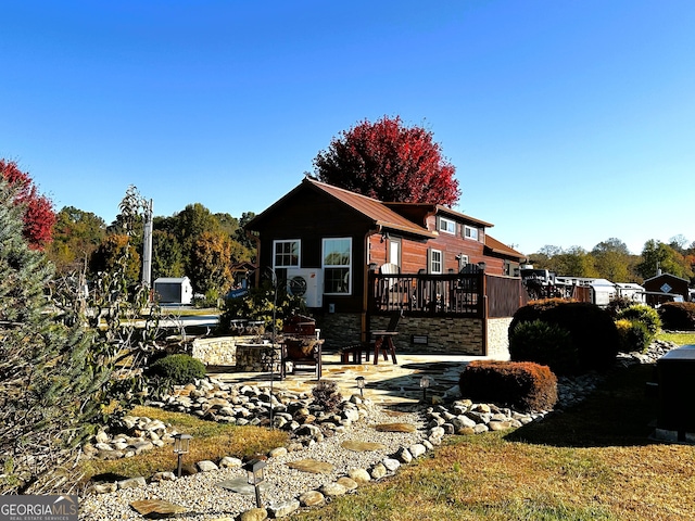 rear view of house featuring a deck