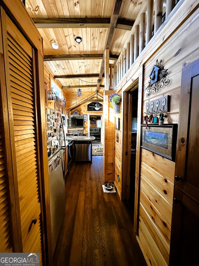 hallway with wood ceiling, wood walls, vaulted ceiling with beams, and dark hardwood / wood-style floors