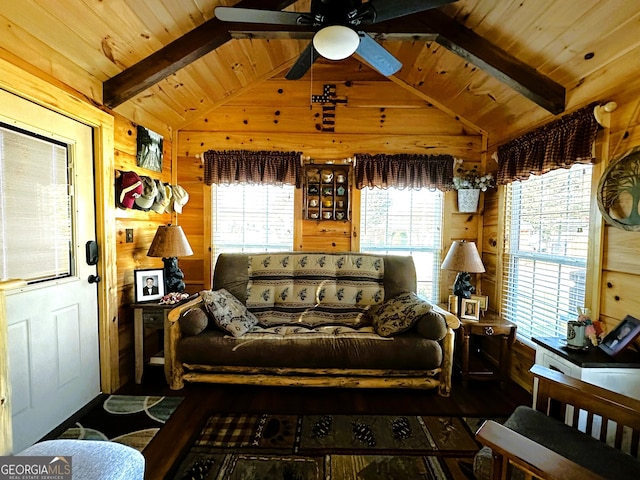 living room with lofted ceiling with beams, ceiling fan, wooden ceiling, and wood walls