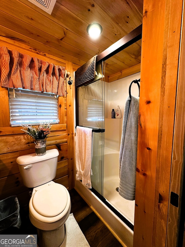 bathroom featuring wood walls, wood ceiling, an enclosed shower, toilet, and hardwood / wood-style flooring